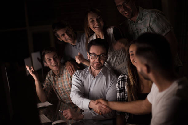 istock boss shaking hands with company employee at the Desk 1026477470