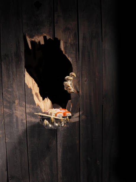 istock Zombie hand through hole cracked in rustic wood.Halloween theme 1026477632