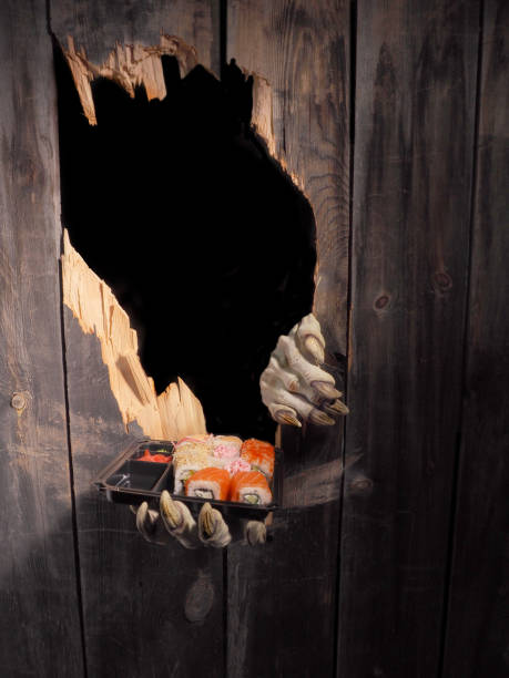 istock Zombie hand through hole cracked in rustic wood.Halloween theme 1026477644