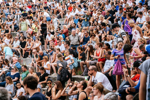 People watching performance of a street artist in the Mauerpark. Mauerpark is a public park in the Prenzlauer Berg district. Flea market in Mauerpark is frequently used as sunday afternoon activity by hip Berliners and tourists. The flea market itself consists of mainly private salespersons who offer various items.