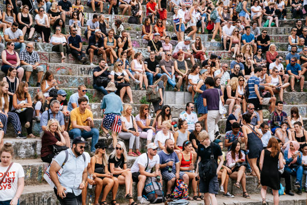 People watching performance of a street artist in the Mauerpark. Mauerpark is a public park in the Prenzlauer Berg district. Flea market in Mauerpark is frequently used as sunday afternoon activity by hip Berliners and tourists. The flea market itself consists of mainly private salespersons who offer various items.