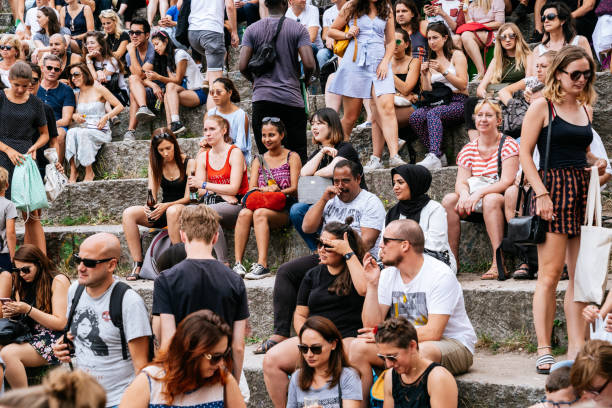 People watching performance of a street artist in the Mauerpark. Mauerpark is a public park in the Prenzlauer Berg district. Flea market in Mauerpark is frequently used as sunday afternoon activity by hip Berliners and tourists. The flea market itself consists of mainly private salespersons who offer various items.