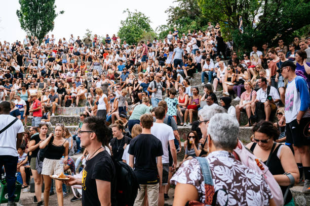People watching performance of a street artist in the Mauerpark. Mauerpark is a public park in the Prenzlauer Berg district. Flea market in Mauerpark is frequently used as sunday afternoon activity by hip Berliners and tourists. The flea market itself consists of mainly private salespersons who offer various items.