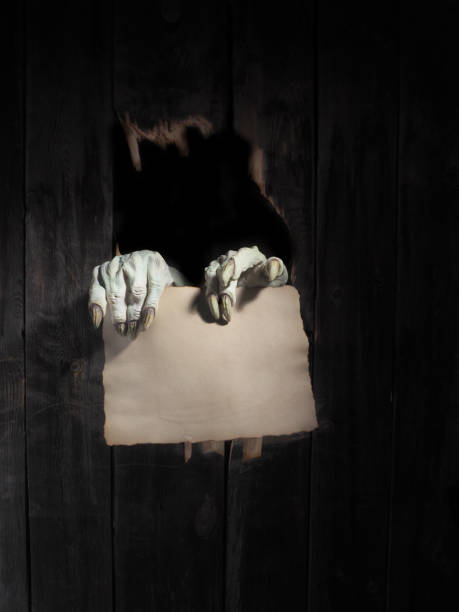 istock Zombie hand through hole cracked in rustic wood.Halloween theme 1026479806