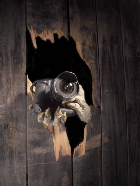istock Zombie hand through hole cracked in rustic wood.Halloween theme 1026480922