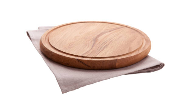 istock Board for pizza and tablecloth isolated on white. Canvas, dish towels on white background top view mock up. Selective focus. 1026488574