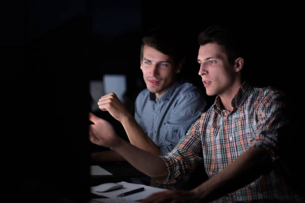 istock office staff working on the computer in the dark 1026489472
