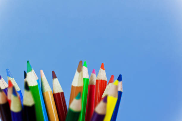 Attractive colored pencils on a blue background