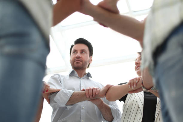 istock boss and the business team form a circle of hands 1026501734