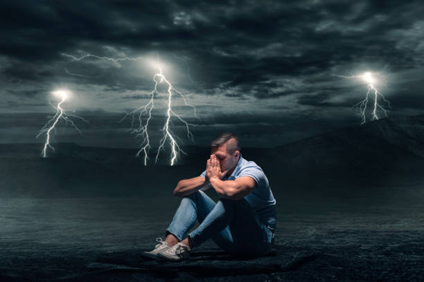 istock Young man sitting on the ground in desert 1026503186