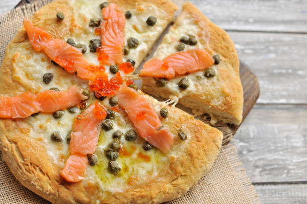 istock Pizza with salmon and basil and capers. Traditional Italian pastries. Copy space 1026507638