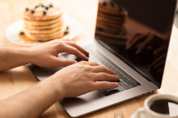 istock Young male hands working on laptop at home 1026513768