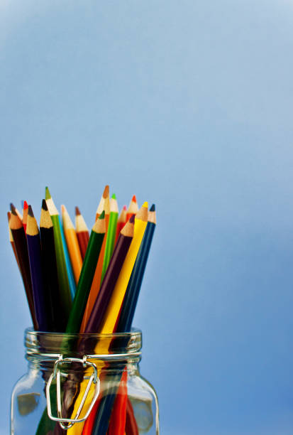 istock coloured pencils in glass jar against blue background 1026518064