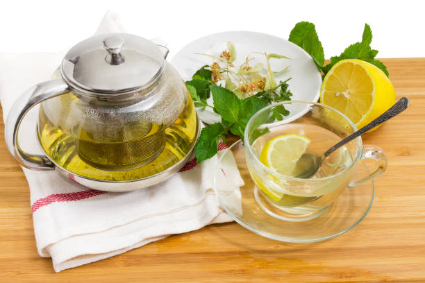 istock Herbal tea in glass teapot and cup, herbs and lemon 1026518508