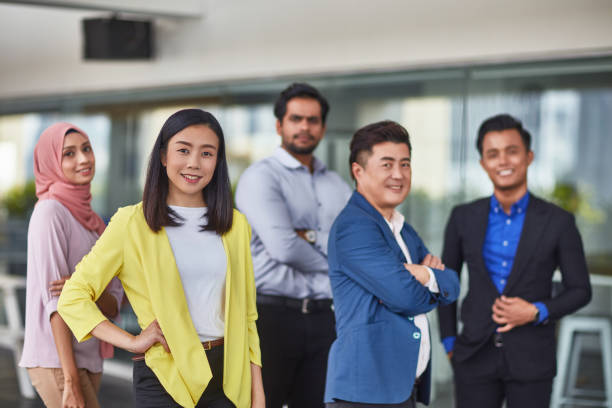 istock Confident businesswoman with team in office 1026524468