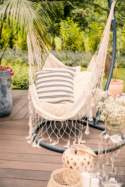 istock Close-up of a string hammock with cushions on a deck in a yard during holiday. 1026529088