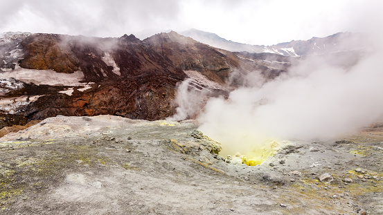 Steaming, sulfuric, active fumaroles near volcano Mutnovsky, Kamchatka Peninsula, Russia