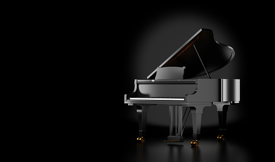 black grand piano isolated on black background