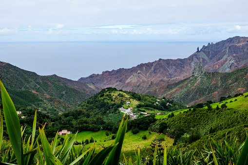 Looking towards Sandy Bay in St Helena and South Atlantic Ocean over volcanic features including geological pillar landmarks of Lot and Lots Wife on the right hand side