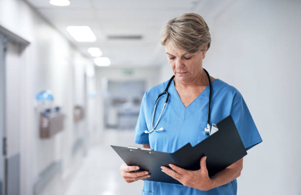 istock Reading her patient's medical records 1026545888