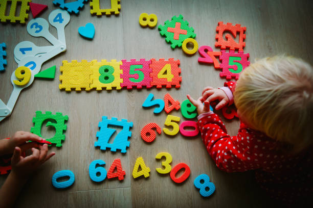 istock kids playing with puzzle, education concept, learning 1026550282