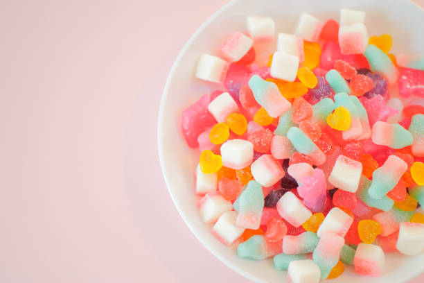 istock Assorted colorful candies on the pink background. 1026551650