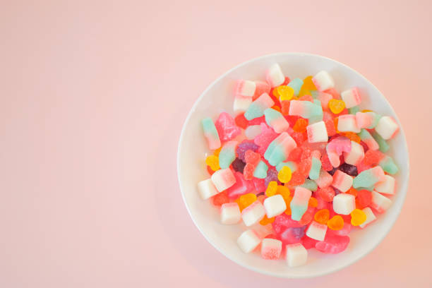 istock Assorted colorful candies on the pink background. 1026551656