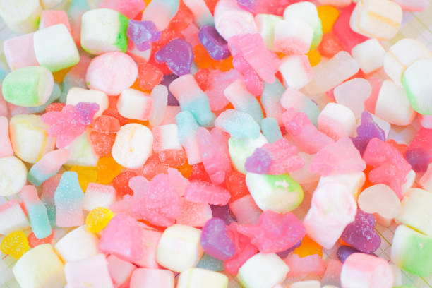 istock Assorted colorful candies on the pink background. 1026551708