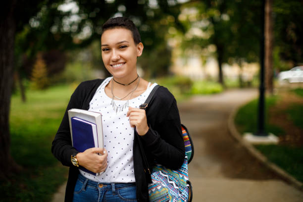 istock Happy female college student with books on university campus 1026562504