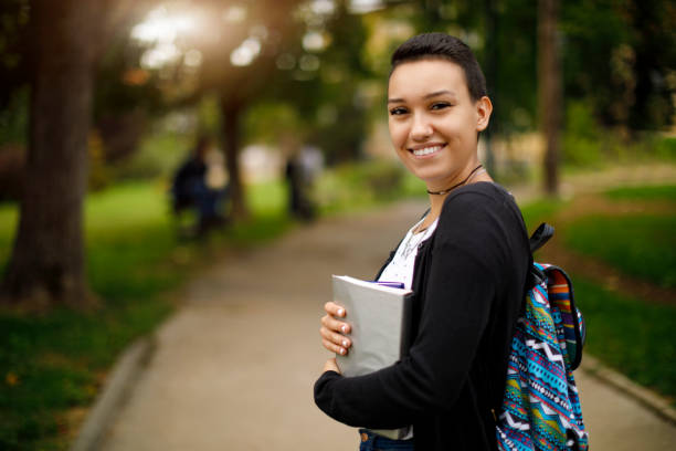 istock Happy female college student with books on university campus 1026562510