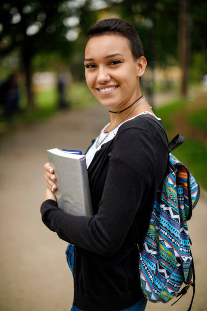 istock Happy female college student with books on university campus 1026562608