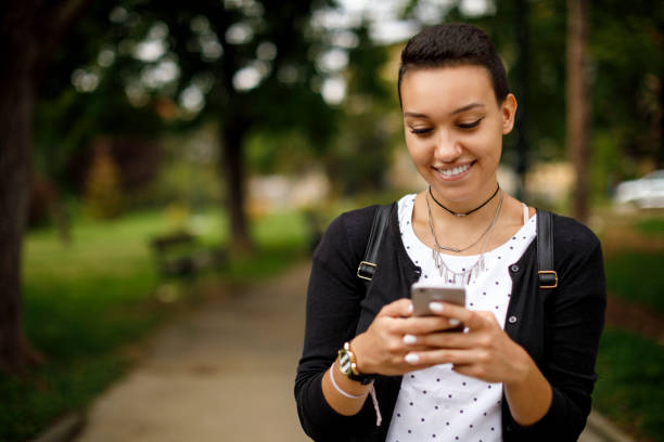 istock Female college student texting on her cell phone outdoors 1026562700