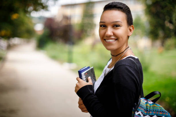 istock Happy female college student with books on university campus 1026563450