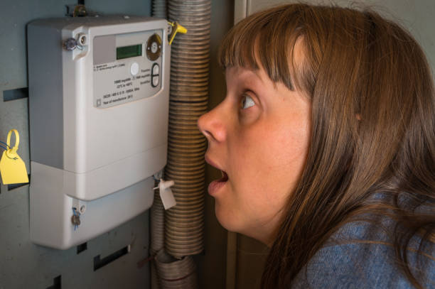 istock Woman is checking electricity meter - expensive electricity concept 1026566308