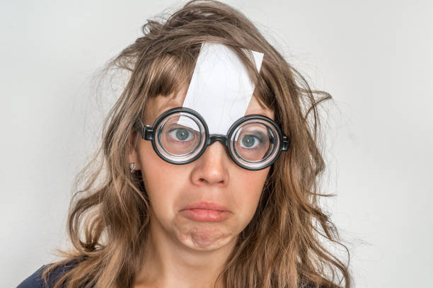 istock Funny woman with blank white sticky paper over her forehead 1026566496