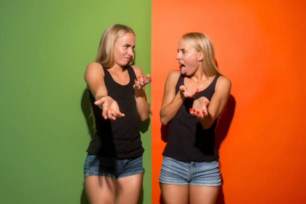 istock Let me think. Doubtful pensive women with thoughtful expression making choice against pink background 1026567050