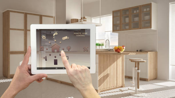 istock Smart remote home control system on a digital tablet. Device with app icons. Blurry interior of minimalist kitchen in the background, architecture design 1026572328