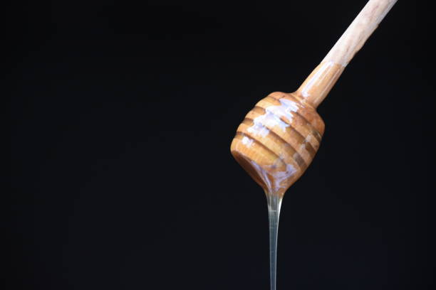 istock Honey spilled on a black background 1026572352