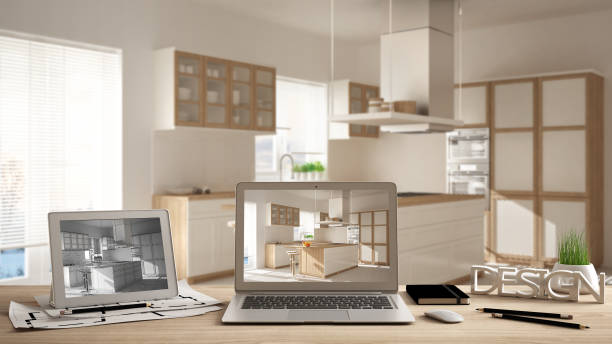 istock Architect designer desktop concept, laptop and tablet on wooden work desk with screen showing interior design project and CAD sketch, blurred draft in the background, modern kitchen idea template 1026572784