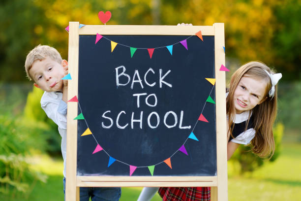 Two adorable schoolkids going back to school
