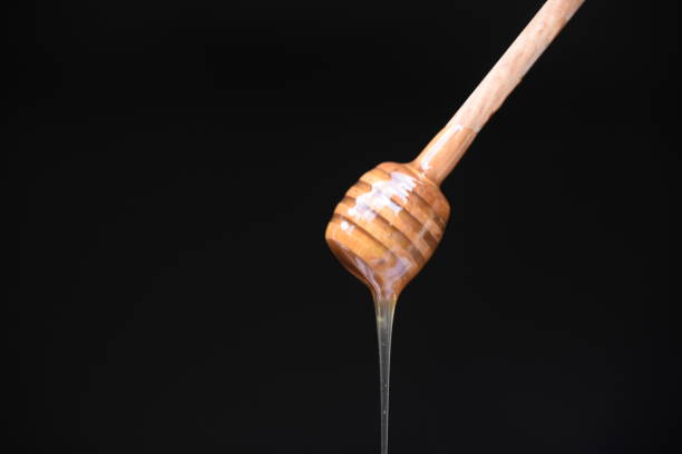 istock Honey spilled on a black background 1026572948