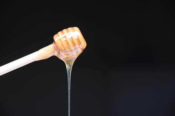 istock Honey spilled on a black background 1026572952