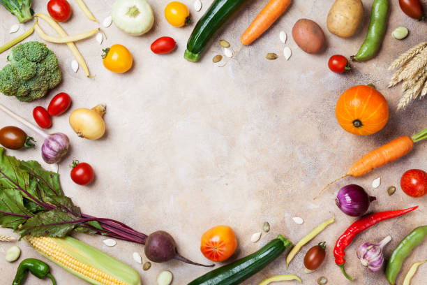 istock Frame of autumn harvest. Vegetables and root on kitchen table top view. 1026576782