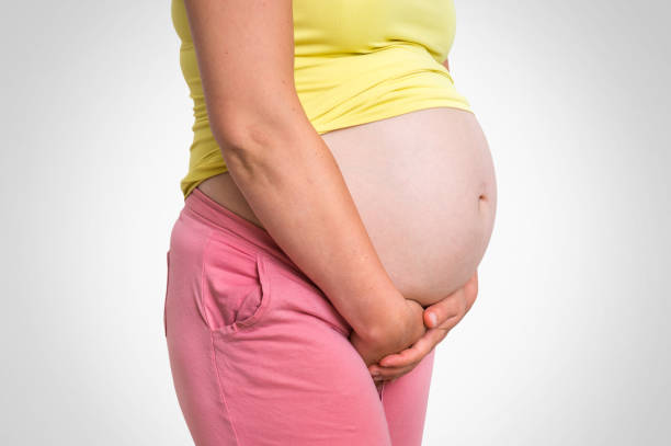 istock Pregnant woman with frequent urination problem 1026576904