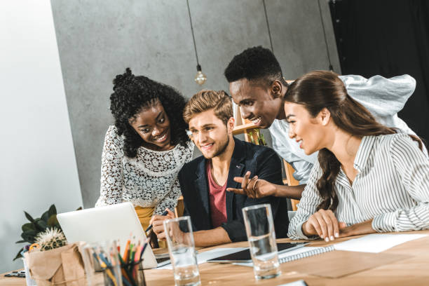 istock multicultural group of business people using laptop together at workplace in office 1026576922