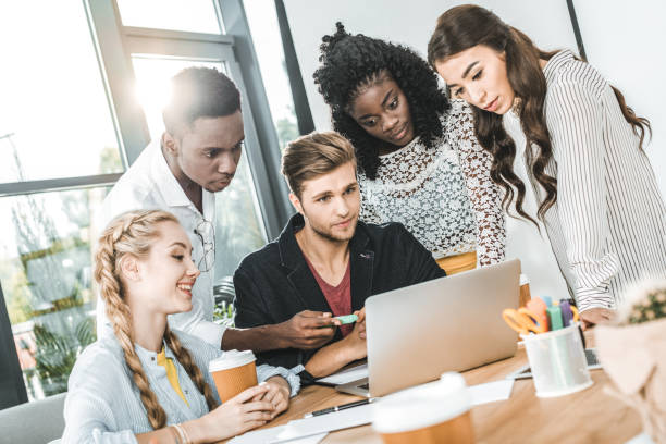 istock multiethnic focused business team working on laptop together at workplace in office 1026577382