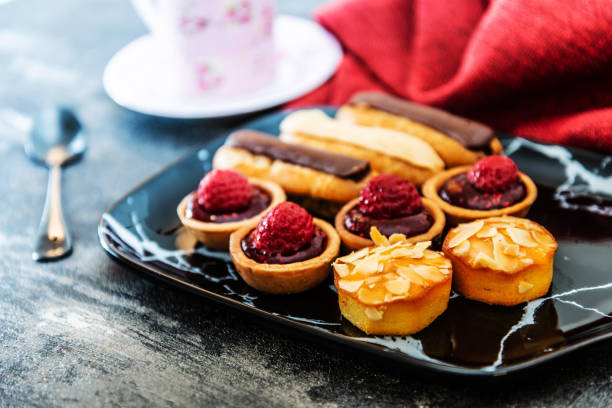istock Mixed dessert Raspberry tartlet, Eclair Puffs, almond lemon 1026580026