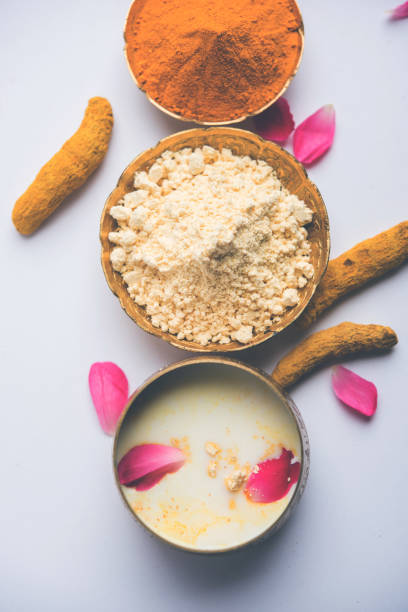 istock Ayurvedic face pack/mask using Gram Flour/besan, Haldi & milk ubtan placed in brass bowls with rose petals, scrub  and white napkin. selective focus 1026580858