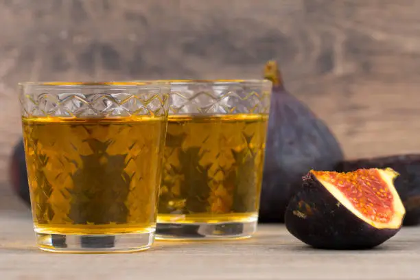 figs liqueur and fresh fruits on rustic table