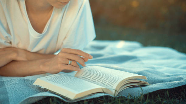 istock Young woman reading a book 1026583974